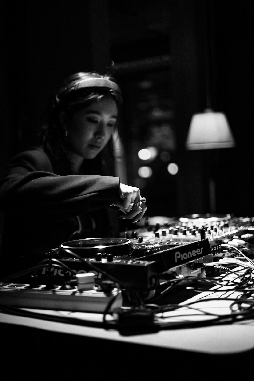 a-woman-djing-at-a-soundboard-in-a-dark-room-lynvh66mg2w